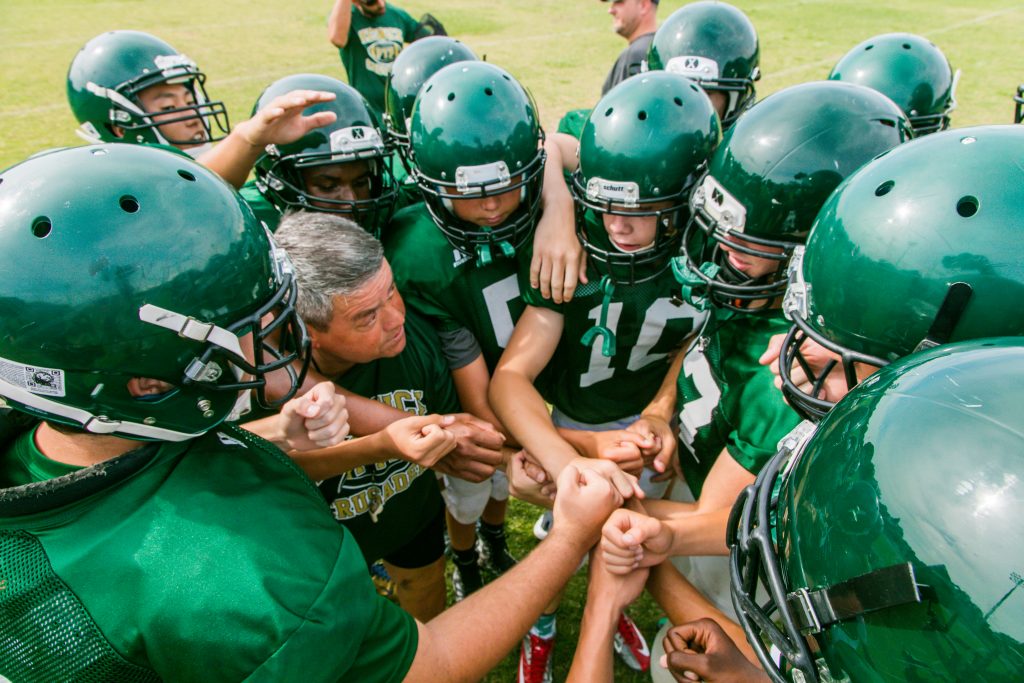 Football Team Huddle - Athletics at Keswick Christian